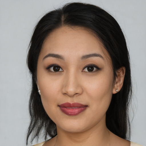 Joyful latino young-adult female with medium  brown hair and brown eyes