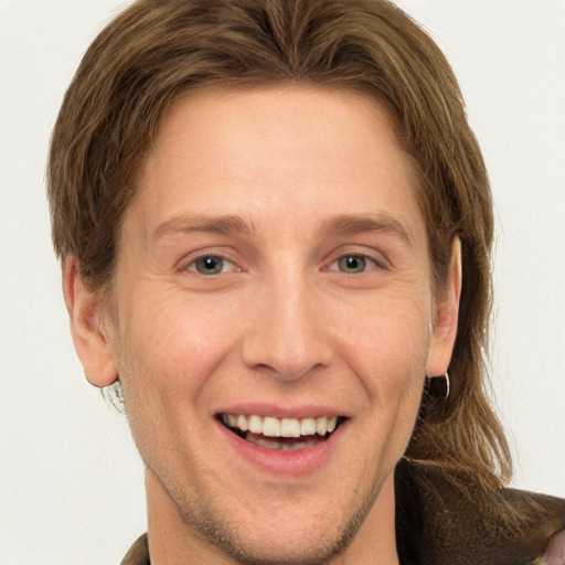 Joyful white adult male with short  brown hair and grey eyes