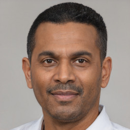 Neutral latino adult male with short  black hair and brown eyes