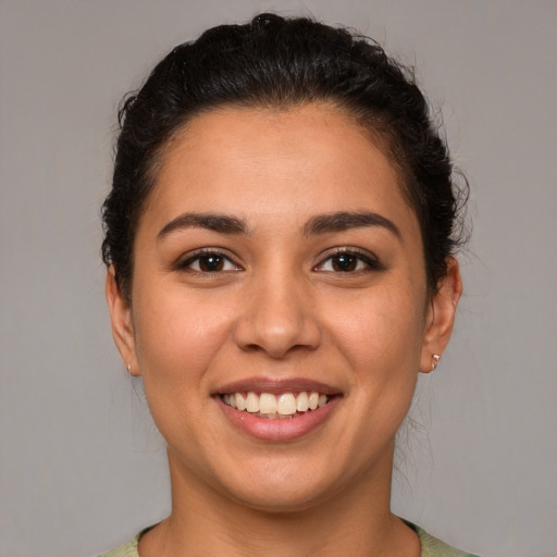 Joyful latino young-adult female with short  brown hair and brown eyes