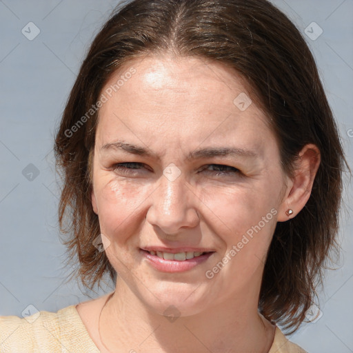 Joyful white adult female with medium  brown hair and brown eyes