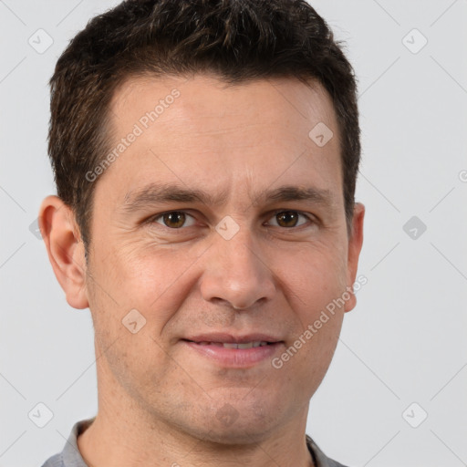 Joyful white adult male with short  brown hair and brown eyes