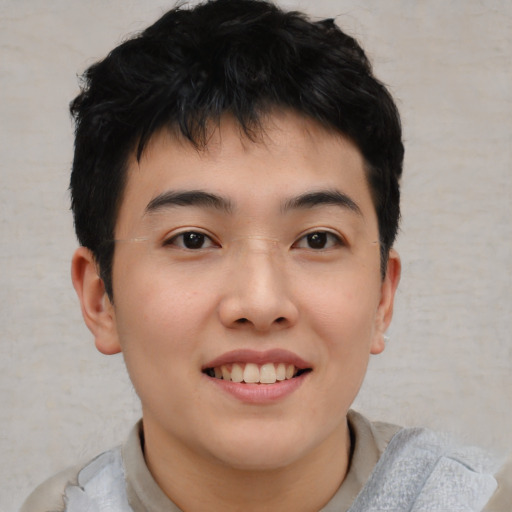 Joyful asian young-adult male with short  black hair and brown eyes