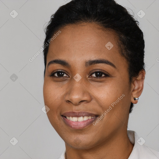 Joyful latino young-adult female with short  black hair and brown eyes