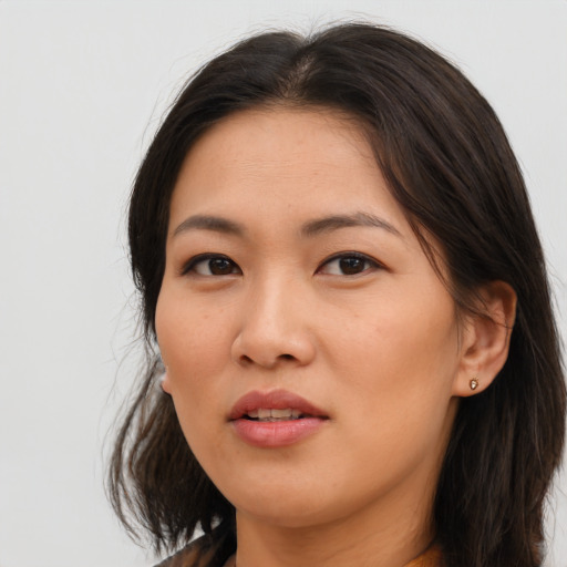 Joyful asian young-adult female with long  brown hair and brown eyes