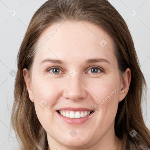 Joyful white young-adult female with long  brown hair and grey eyes