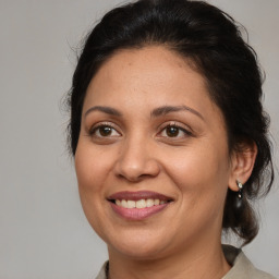 Joyful white adult female with medium  brown hair and brown eyes