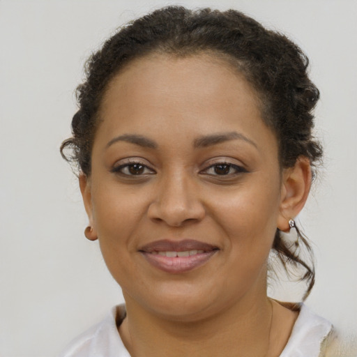 Joyful black young-adult female with short  brown hair and brown eyes
