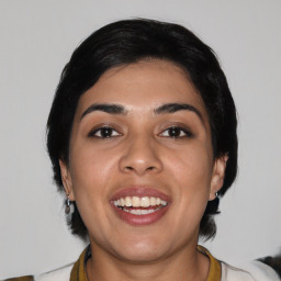 Joyful latino young-adult female with medium  black hair and brown eyes