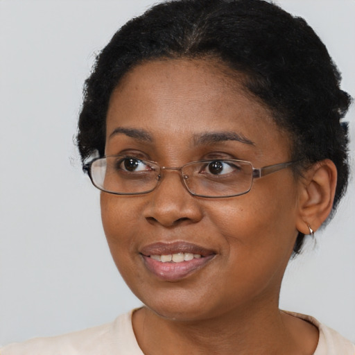 Joyful black adult female with short  brown hair and brown eyes