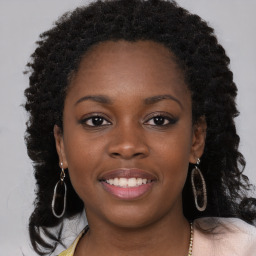 Joyful black young-adult female with long  brown hair and brown eyes