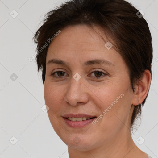 Joyful white adult female with short  brown hair and brown eyes