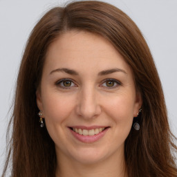 Joyful white young-adult female with long  brown hair and grey eyes