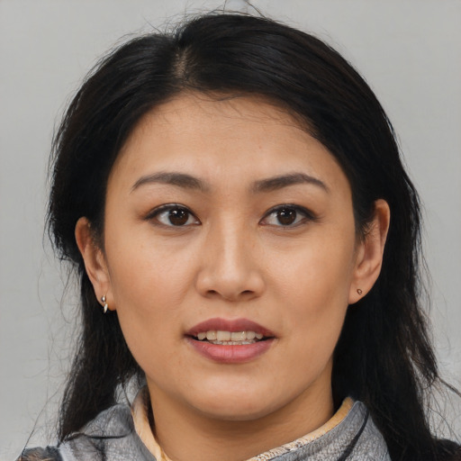 Joyful latino young-adult female with medium  black hair and brown eyes