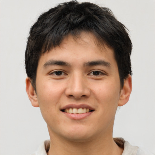 Joyful asian young-adult male with short  brown hair and brown eyes
