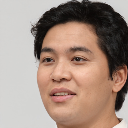 Joyful asian young-adult male with medium  black hair and brown eyes