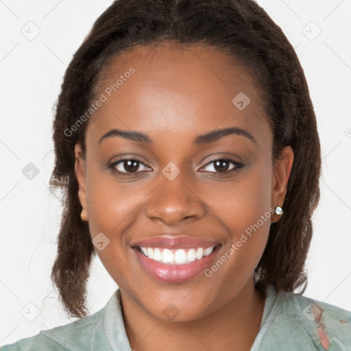 Joyful black young-adult female with long  brown hair and brown eyes