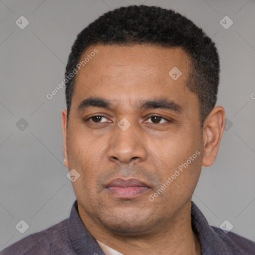 Neutral latino adult male with short  black hair and brown eyes