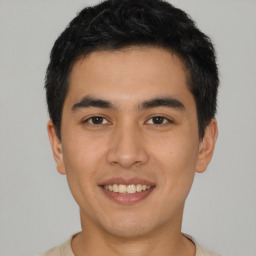 Joyful asian young-adult male with short  black hair and brown eyes