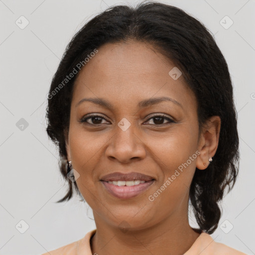 Joyful black adult female with medium  brown hair and brown eyes