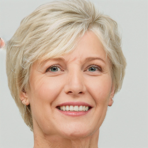 Joyful white middle-aged female with short  blond hair and blue eyes