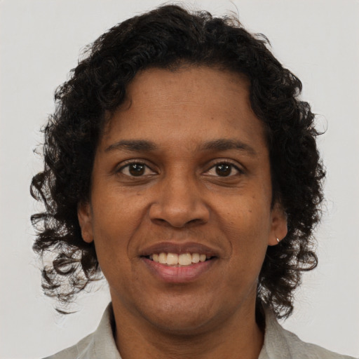 Joyful black adult female with short  brown hair and brown eyes