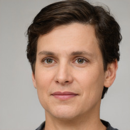 Joyful white adult male with short  brown hair and grey eyes