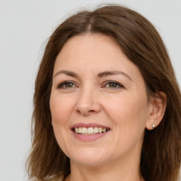 Joyful white adult female with long  brown hair and brown eyes