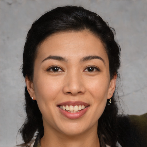 Joyful asian young-adult female with medium  brown hair and brown eyes