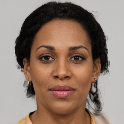 Joyful black adult female with medium  brown hair and brown eyes