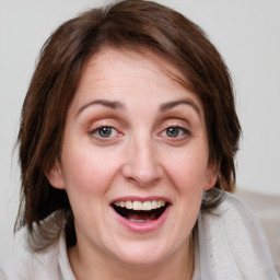 Joyful white young-adult female with medium  brown hair and blue eyes