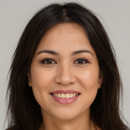 Joyful white young-adult female with long  brown hair and brown eyes