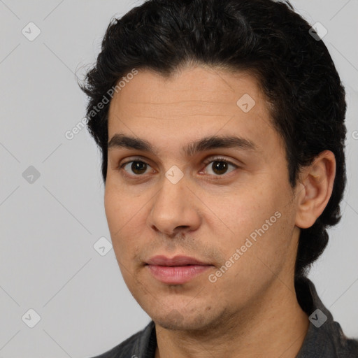 Joyful white young-adult male with short  black hair and brown eyes