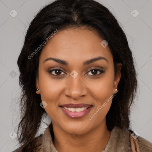 Joyful black young-adult female with long  brown hair and brown eyes