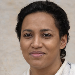 Joyful black adult female with short  brown hair and brown eyes