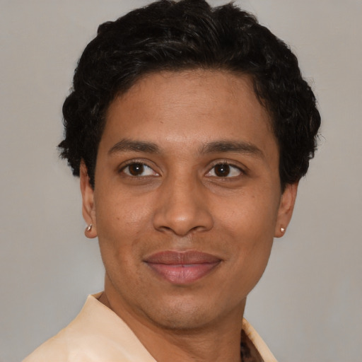 Joyful latino adult male with short  black hair and brown eyes