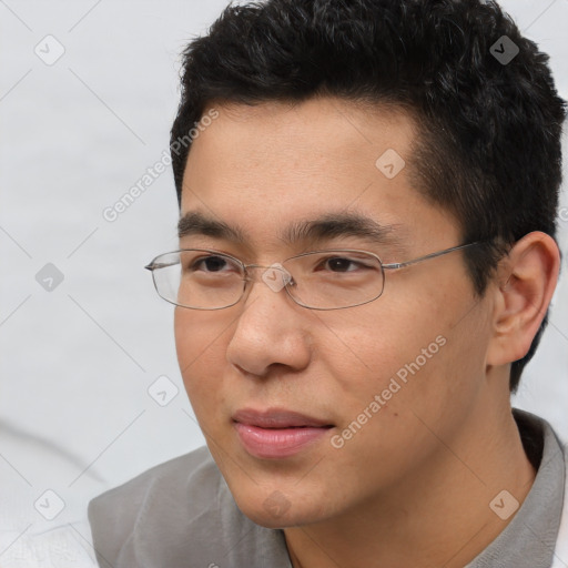 Joyful asian young-adult male with short  brown hair and brown eyes