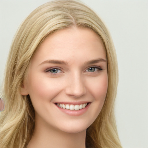 Joyful white young-adult female with long  brown hair and blue eyes