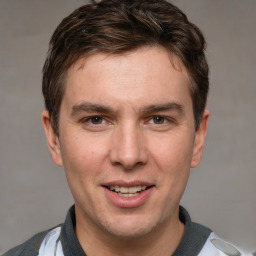 Joyful white adult male with short  brown hair and grey eyes