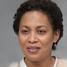 Joyful black adult female with short  brown hair and brown eyes