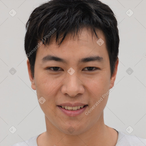 Joyful asian young-adult male with short  black hair and brown eyes