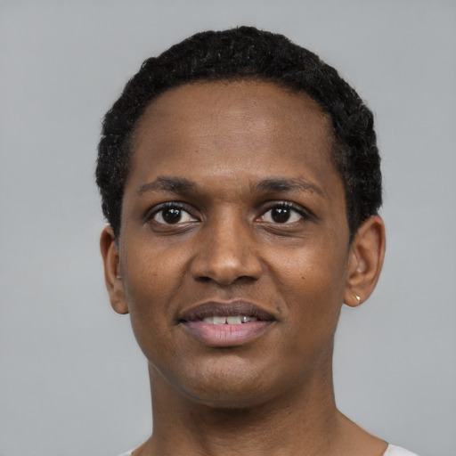 Joyful black young-adult male with short  black hair and brown eyes