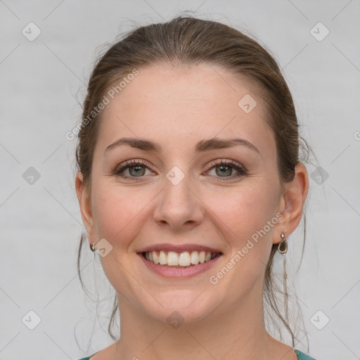 Joyful white young-adult female with medium  brown hair and blue eyes