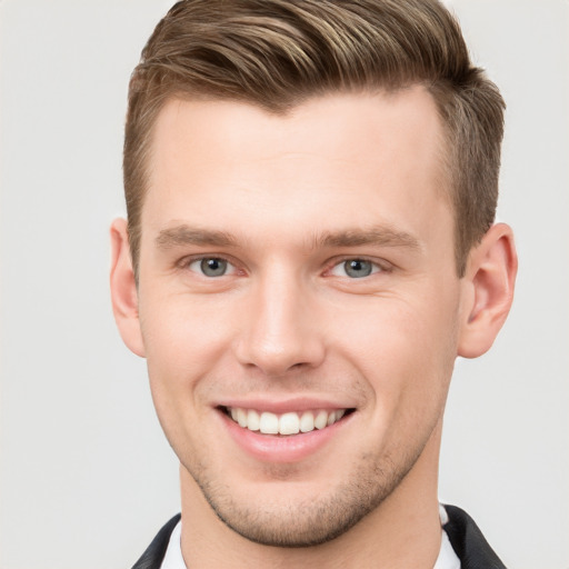 Joyful white young-adult male with short  brown hair and grey eyes