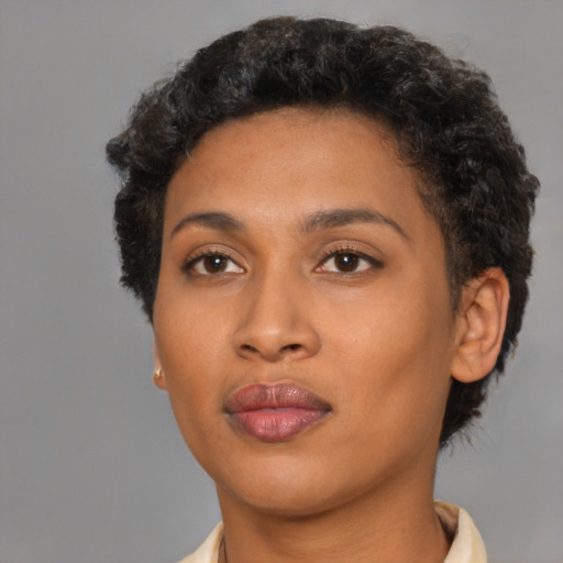 Joyful black young-adult female with short  brown hair and brown eyes