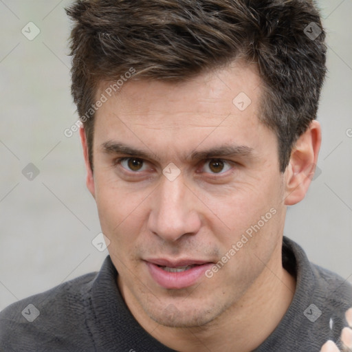 Joyful white adult male with short  brown hair and brown eyes