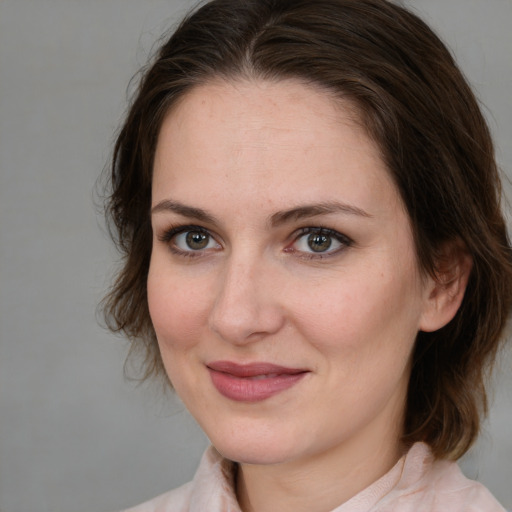 Joyful white adult female with medium  brown hair and brown eyes