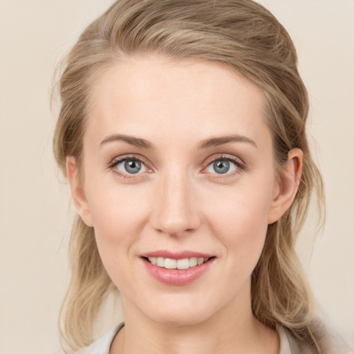 Joyful white young-adult female with medium  brown hair and blue eyes