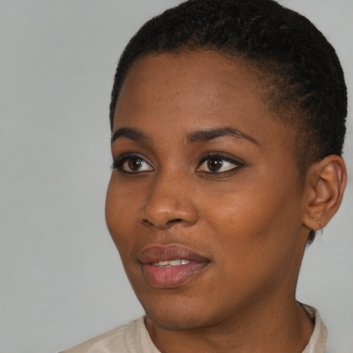 Joyful black young-adult female with short  brown hair and brown eyes