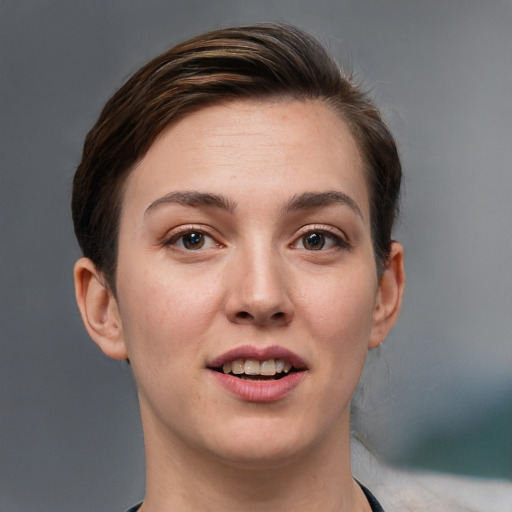 Joyful white young-adult female with short  brown hair and grey eyes